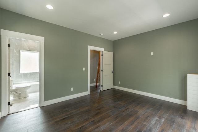 interior space featuring baseboards, recessed lighting, ensuite bath, and dark wood-style floors