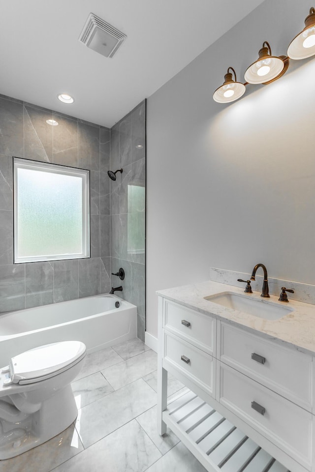 full bathroom with vanity, toilet, marble finish floor, tub / shower combination, and visible vents