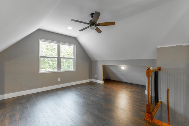 bonus room featuring a ceiling fan, baseboards, vaulted ceiling, and dark wood finished floors