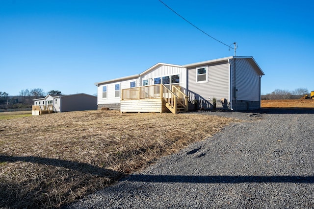 back of house featuring crawl space and a wooden deck
