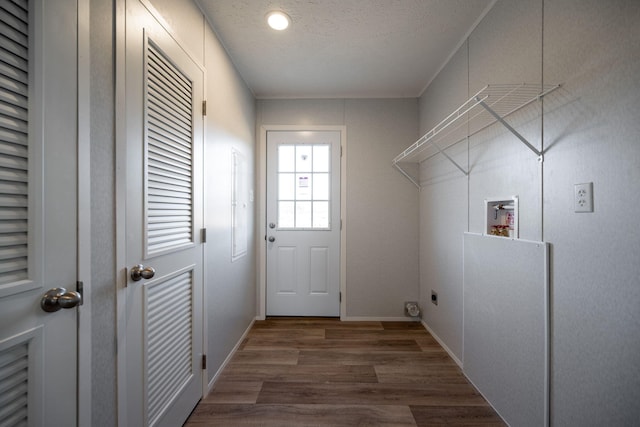 laundry area featuring washer hookup, a textured ceiling, baseboards, wood finished floors, and laundry area