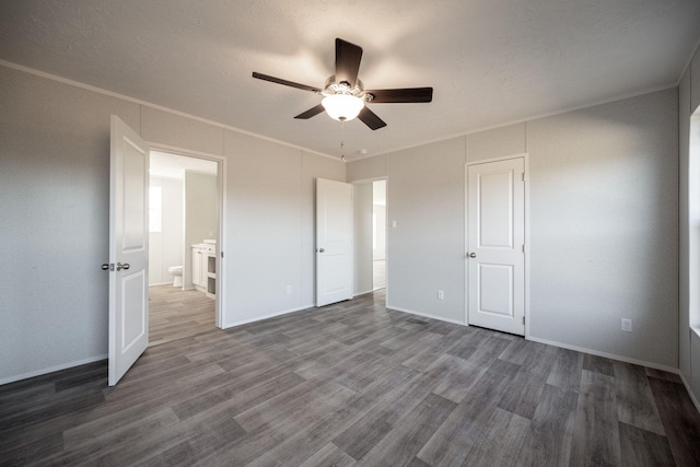 unfurnished bedroom with baseboards, wood finished floors, a ceiling fan, and crown molding