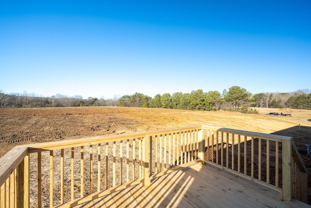wooden terrace featuring a rural view