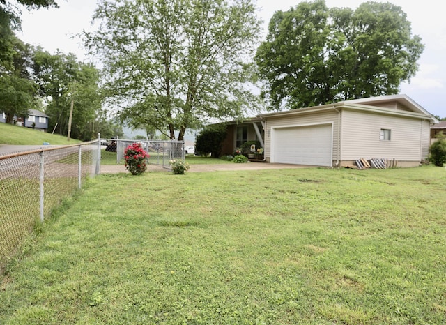 3421 Franklin Dr, Chattanooga, TN 37419 - view of yard featuring an attached garage and concrete driveway