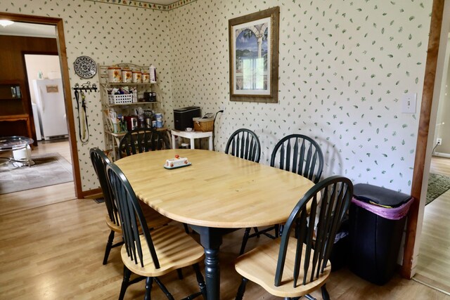 3421 Franklin Dr, Chattanooga, TN 37419 - dining space with wallpapered walls, light wood-style flooring, and baseboards