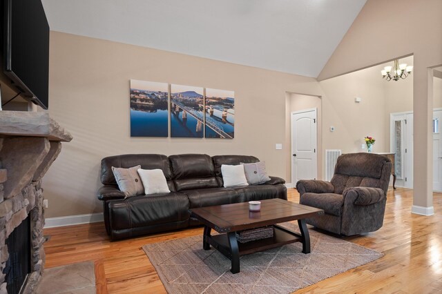 745 Soaring Eagle Cir, Hixson, TN 37343 - living area with visible vents, baseboards, high vaulted ceiling, light wood finished floors, and a notable chandelier