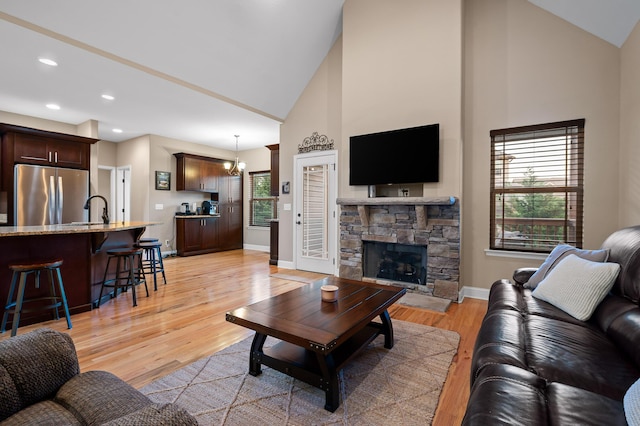 745 Soaring Eagle Cir, Hixson, TN 37343 - living room featuring baseboards, high vaulted ceiling, recessed lighting, light wood finished floors, and a notable chandelier