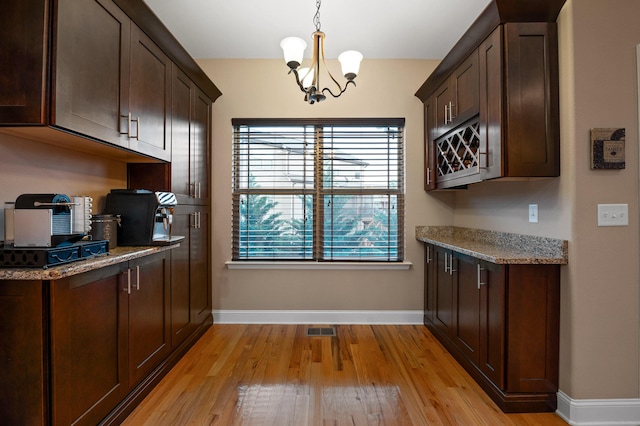 745 Soaring Eagle Cir, Hixson, TN 37343 - kitchen with baseboards, light wood finished floors, and dark brown cabinetry