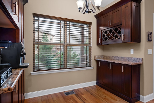 745 Soaring Eagle Cir, Hixson, TN 37343 - bar with an inviting chandelier, baseboards, light wood finished floors, and visible vents