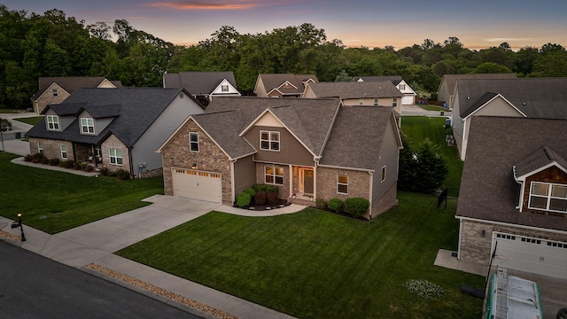 745 Soaring Eagle Cir, Hixson, TN 37343 - view of front of house featuring roof with shingles, driveway, stone siding, and a front lawn