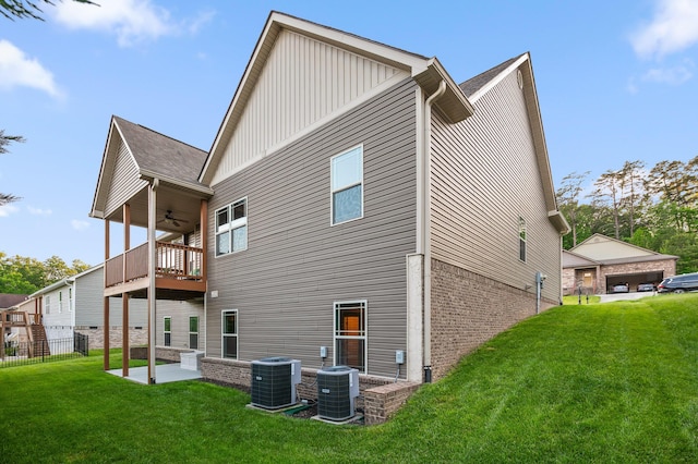 745 Soaring Eagle Cir, Hixson, TN 37343 - rear view of property featuring board and batten siding, ceiling fan, cooling unit, a balcony, and a lawn