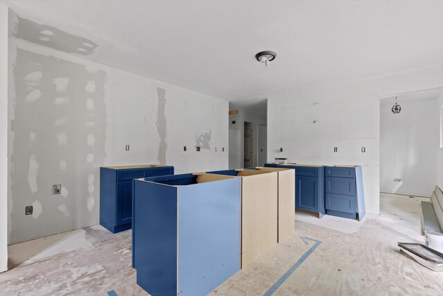 6475 Polly Ln, Signal Mountain, TN 37377 - kitchen with blue cabinetry and a center island