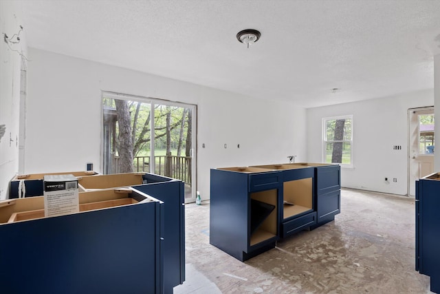 6475 Polly Ln, Signal Mountain, TN 37377 - kitchen with blue cabinets, a textured ceiling, and a center island