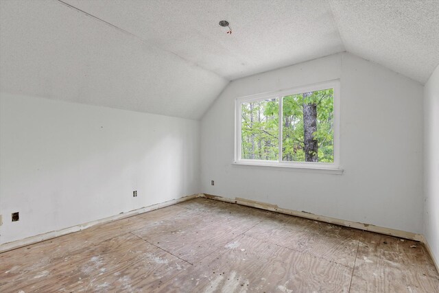 6475 Polly Ln, Signal Mountain, TN 37377 - additional living space featuring vaulted ceiling and a textured ceiling