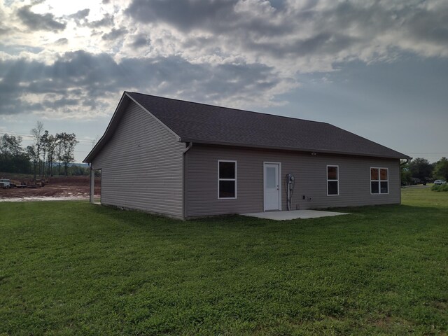 back of house with a patio area and a yard
