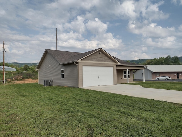 view of front of house with a garage, central air condition unit, driveway, and a front lawn