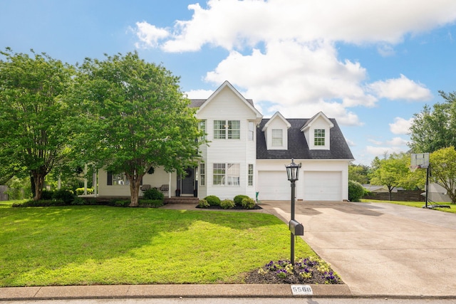 view of front of property featuring a garage, a front yard, and driveway
