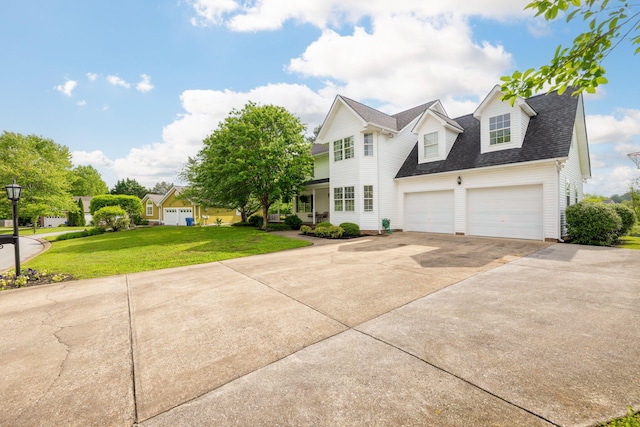 view of front of property with an attached garage, concrete driveway, a shingled roof, and a front lawn