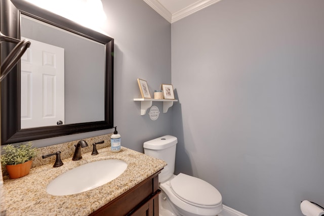 bathroom featuring crown molding, toilet, and vanity