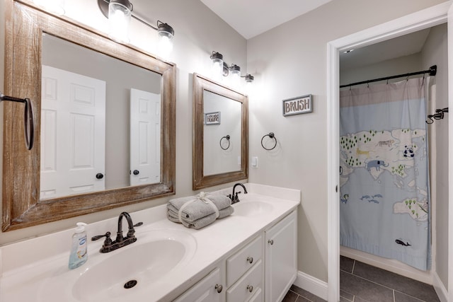 bathroom featuring double vanity, curtained shower, tile patterned flooring, and a sink