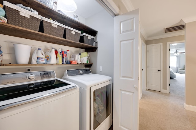 washroom featuring laundry area, light colored carpet, visible vents, separate washer and dryer, and crown molding