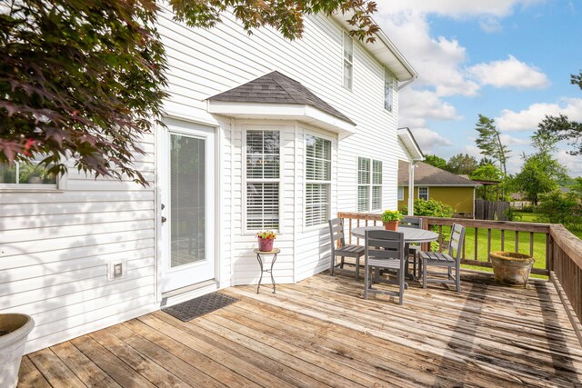wooden deck featuring outdoor dining area