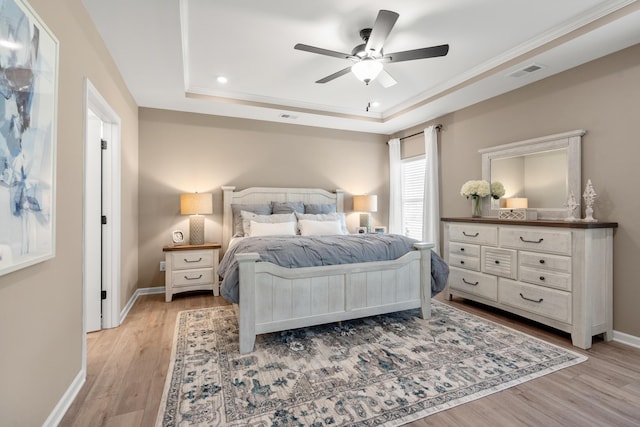 8418 Snowdrop Way, Ooltewah, TN 37363 - bedroom featuring baseboards, visible vents, light wood-type flooring, and a tray ceiling