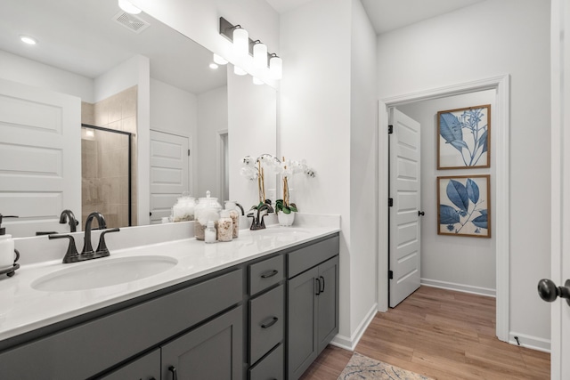 8418 Snowdrop Way, Ooltewah, TN 37363 - bathroom featuring visible vents, wood finished floors, a shower stall, and a sink
