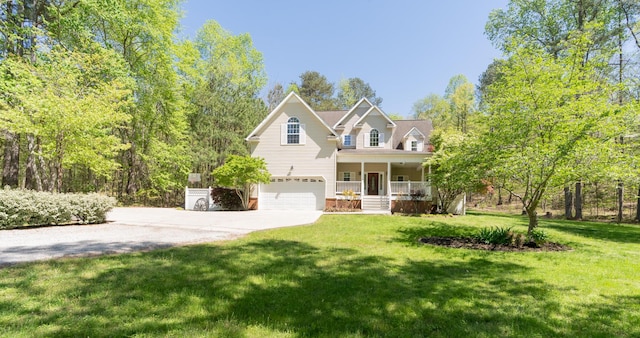 traditional-style home with a front yard, concrete driveway, a porch, and an attached garage