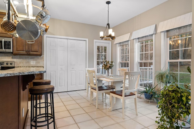 dining room featuring a chandelier and light tile patterned flooring