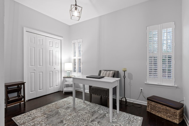 office with dark wood-style flooring and baseboards