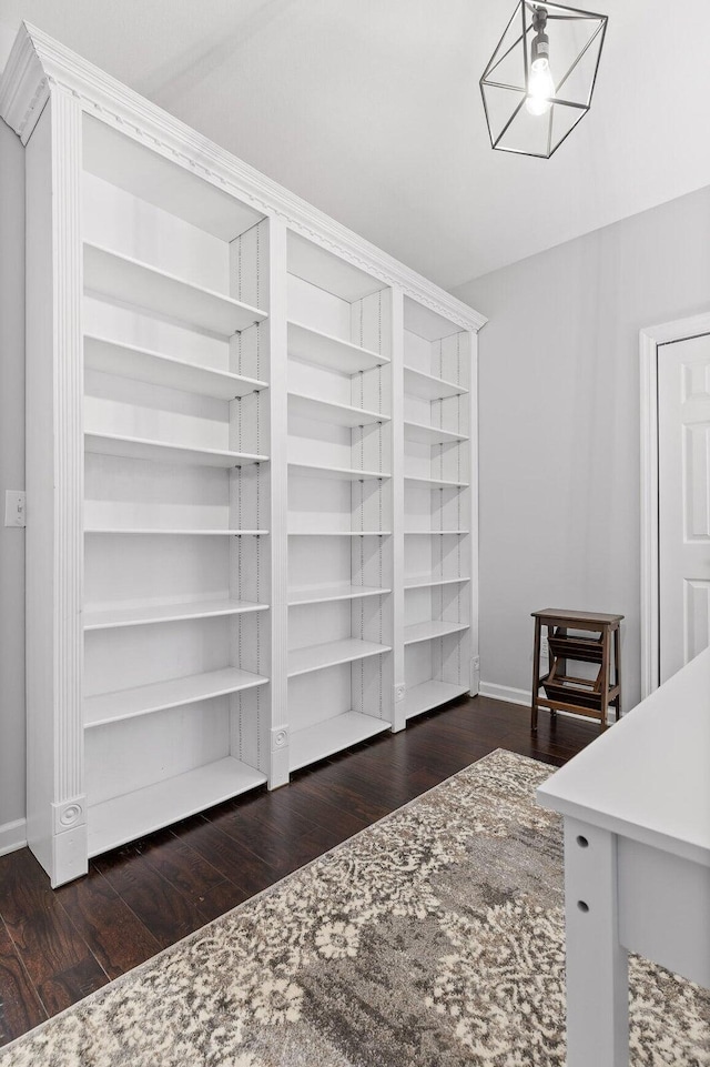 interior space featuring baseboards and wood finished floors
