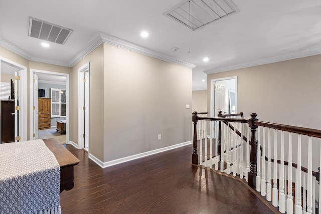 hall with attic access, recessed lighting, an upstairs landing, visible vents, and hardwood / wood-style flooring
