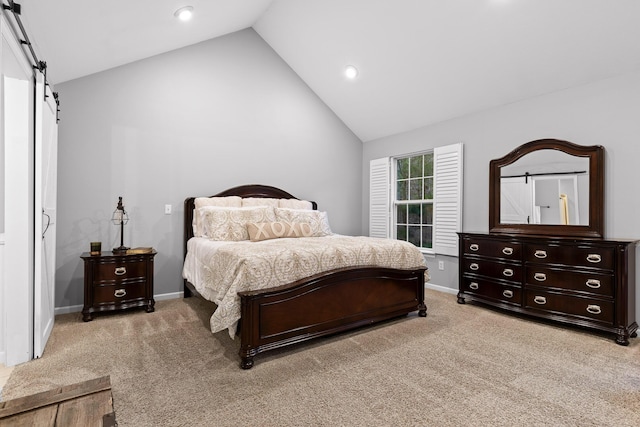 bedroom featuring a barn door, recessed lighting, light carpet, and vaulted ceiling