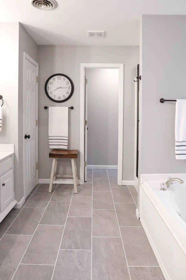 full bathroom with tile patterned floors, visible vents, vanity, and a bath