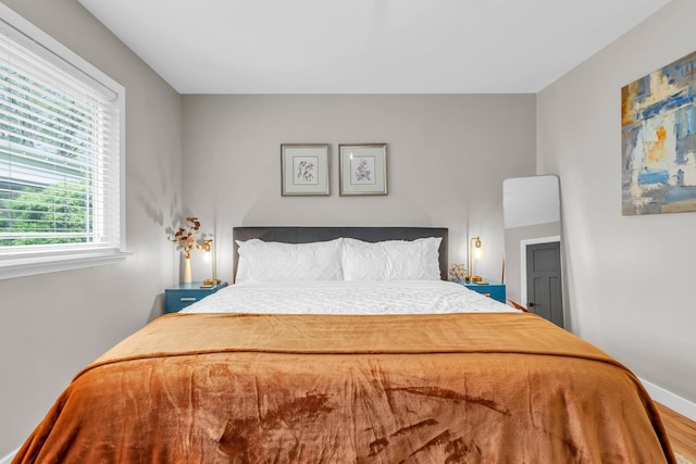 bedroom with wood finished floors and baseboards