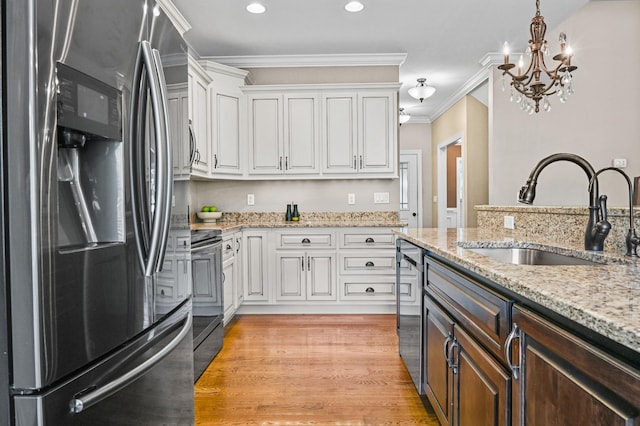 89 Kailors Cove Cir, Ringgold, GA 30736 - kitchen with stainless steel appliances, a sink, white cabinets, hanging light fixtures, and a chandelier