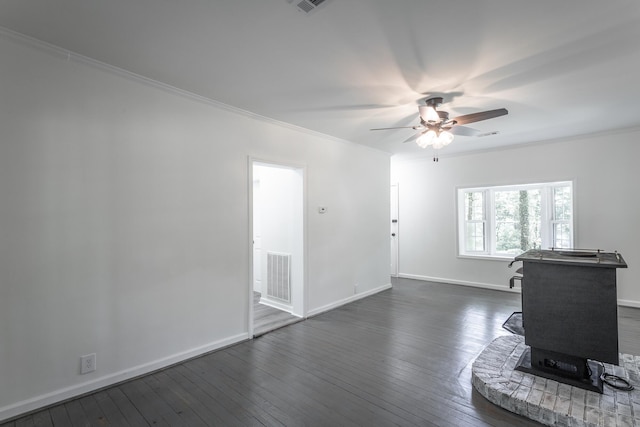 504 1st St, Lafayette, GA 30728 - living room featuring ceiling fan, crown molding, dark wood-type flooring, a wood stove, and baseboards