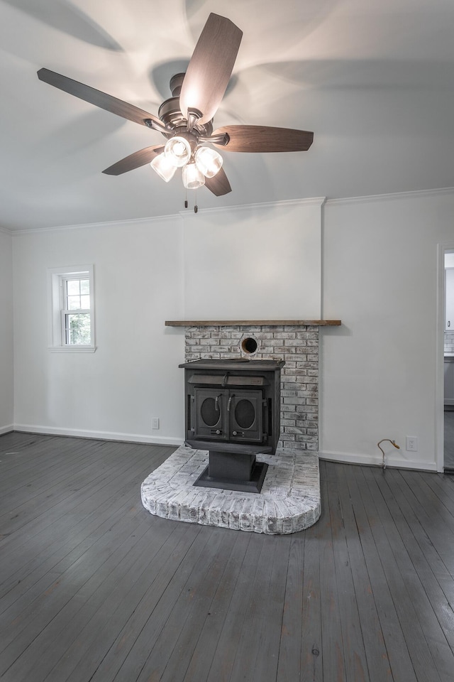 504 1st St, Lafayette, GA 30728 - unfurnished living room featuring ornamental molding, a ceiling fan, baseboards, dark wood-type flooring, and a wood stove
