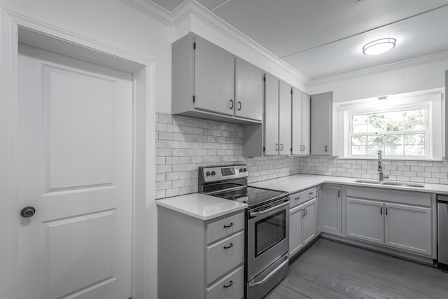 504 1st St, Lafayette, GA 30728 - kitchen featuring appliances with stainless steel finishes, a sink, gray cabinetry, light countertops, and ornamental molding