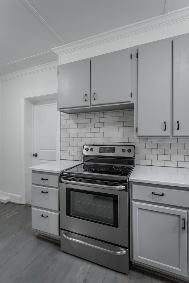 504 1st St, Lafayette, GA 30728 - kitchen featuring electric stove, ornamental molding, light countertops, backsplash, and wood finished floors