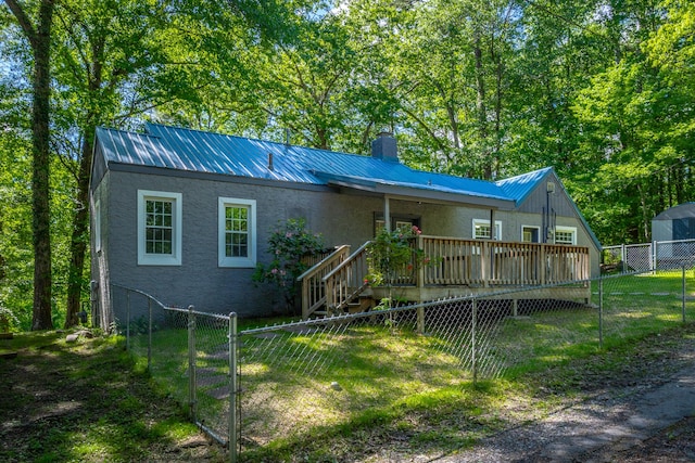 504 1st St, Lafayette, GA 30728 - view of front of house featuring a chimney, a fenced backyard, stucco siding, metal roof, and a wooden deck