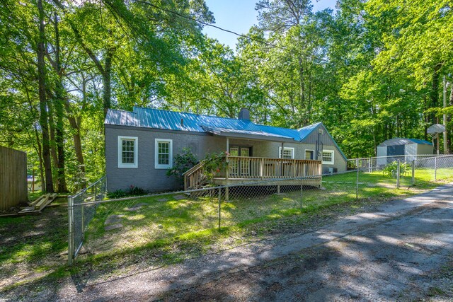 504 1st St, Lafayette, GA 30728 - view of front of property with a deck, a chimney, metal roof, and stucco siding