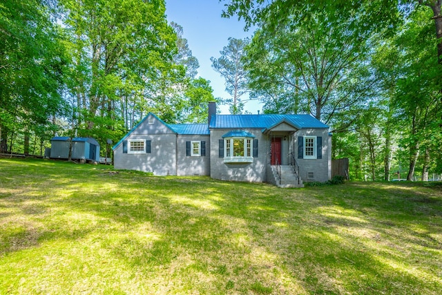 504 1st St, Lafayette, GA 30728 - view of front facade with a chimney, a front lawn, a shed, and metal roof
