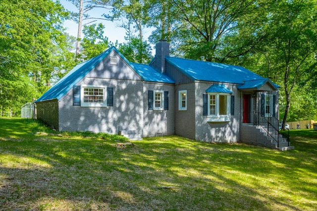 504 1st St, Lafayette, GA 30728 - rear view of property with a chimney, a lawn, and metal roof