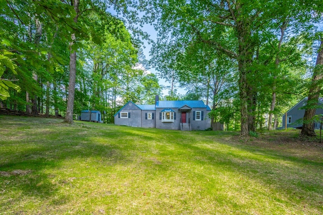504 1st St, Lafayette, GA 30728 - view of front of home featuring a shed, a front yard, an outdoor structure, and metal roof