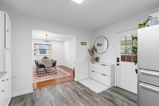 3818 Granada Dr, Chattanooga, TN 37411 - entrance foyer with a chandelier, wood finished floors, healthy amount of natural light, and baseboards