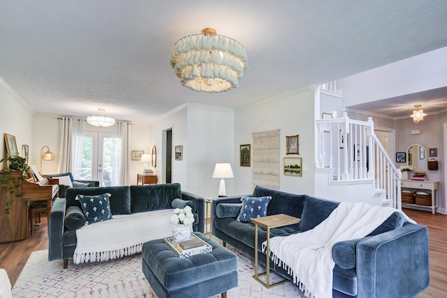 204 Stonecrest Cir, Ringgold, GA 30736 - living room featuring a chandelier, wood finished floors, ornamental molding, and stairs