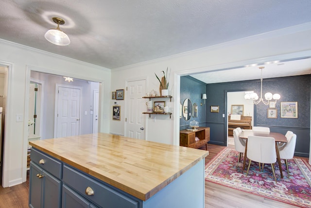 204 Stonecrest Cir, Ringgold, GA 30736 - kitchen with wooden counters, a chandelier, wood finished floors, crown molding, and blue cabinets