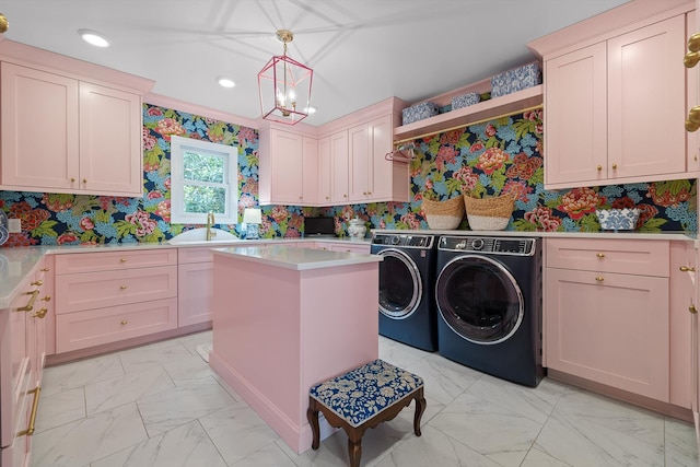 laundry area with marble finish floor, washer and dryer, wallpapered walls, a sink, and cabinet space